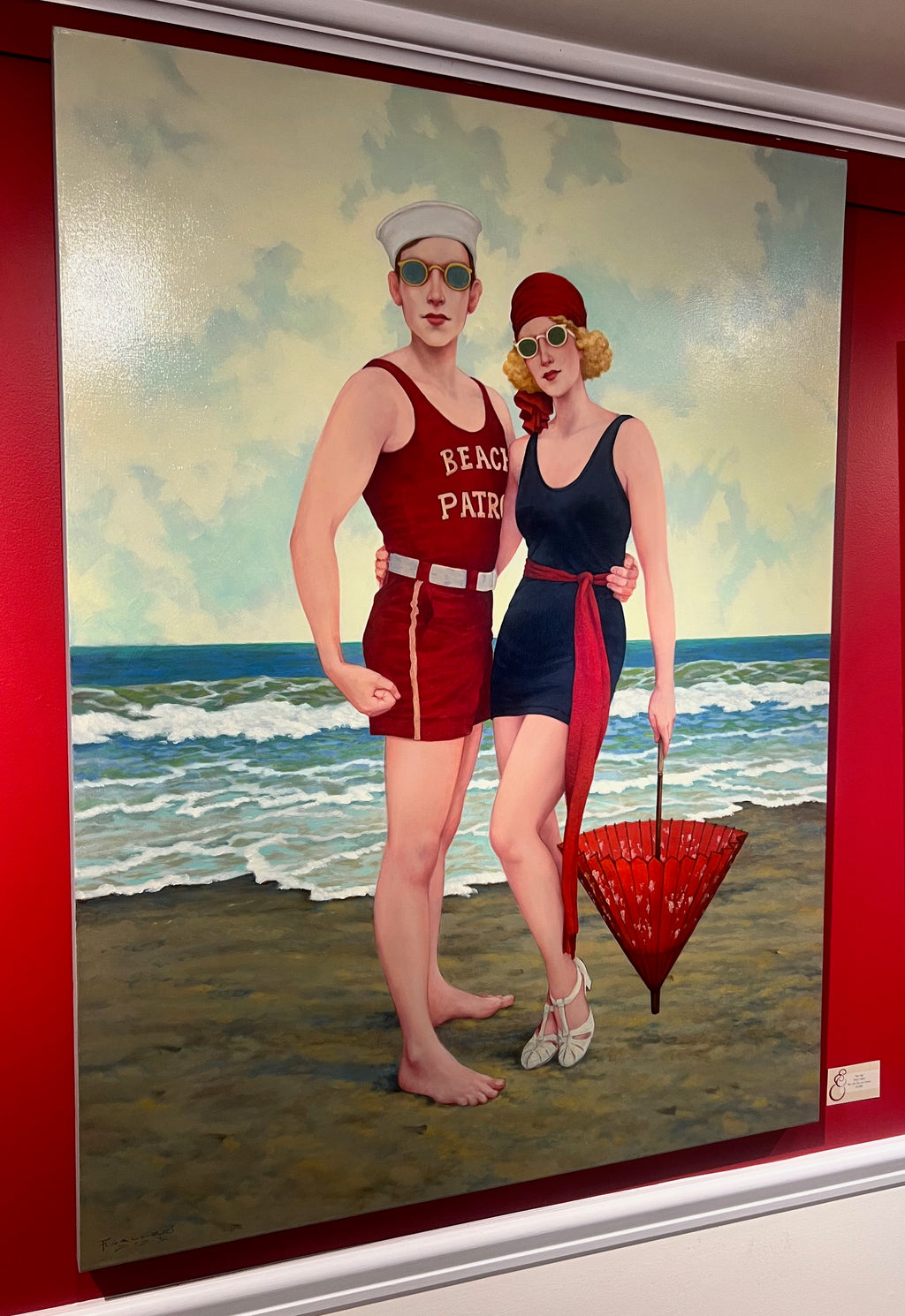 Oil painting of a man and woman in vintage bathing suits and red parasol standing on the shore of a beach
