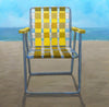 still life oil painting of a yellow and white beach chair sitting in the snd in front of the ocean