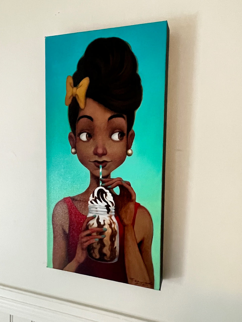 Figurative portrait of young, black girl sipping a chocolate milkshake. She wears a yellow bow in her hair and a red shirt.