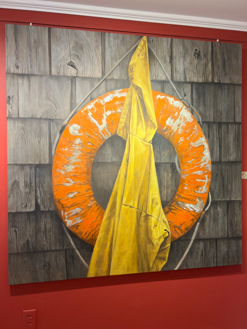 Nautical, still life, oil painting of worn down orange life buoy and a yellow rainjacket hanging on a dark shingled building wall