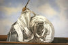 Oil painting by Michel Brosseau of a sail wrapped up resembling the shape of a snail. we can see a an overcast yet blue sky in the background.