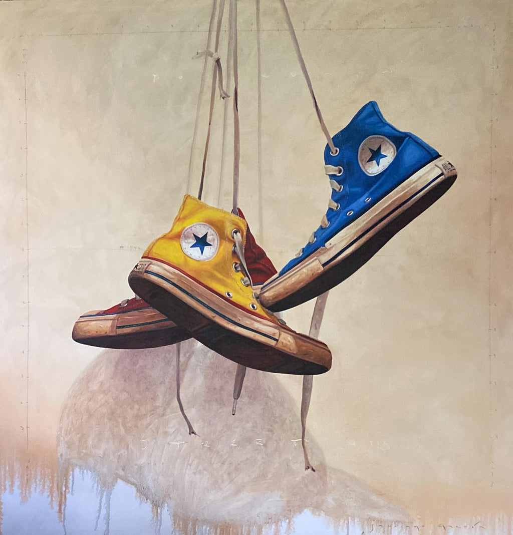 painting of a red, yellow and blue converse shoes hanging
