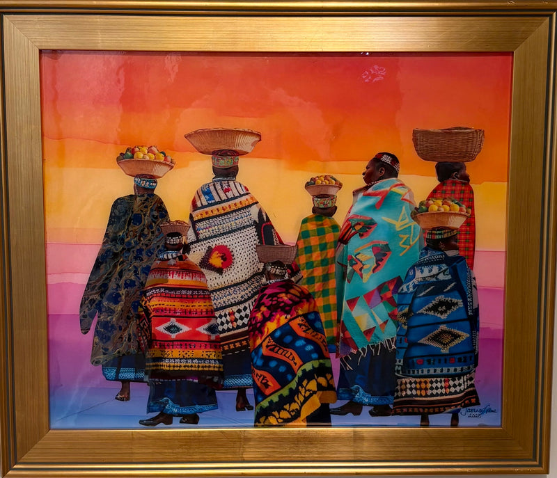 framed work with women walking together, baskets on their heads. They are each wrapped in a colorful, patterned cloth