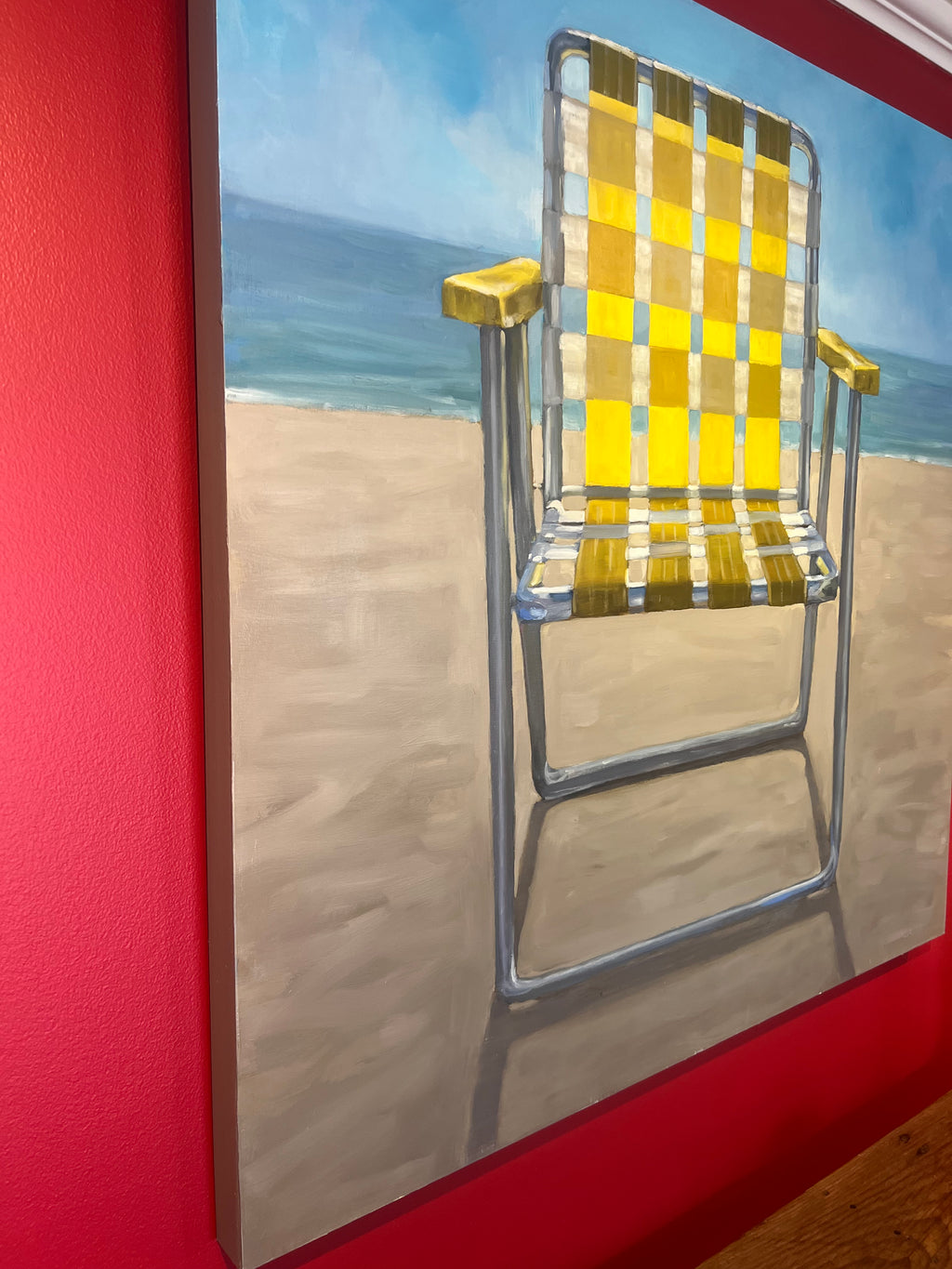 still life oil painting of a yellow and white beach chair sitting in the snd in front of the ocean