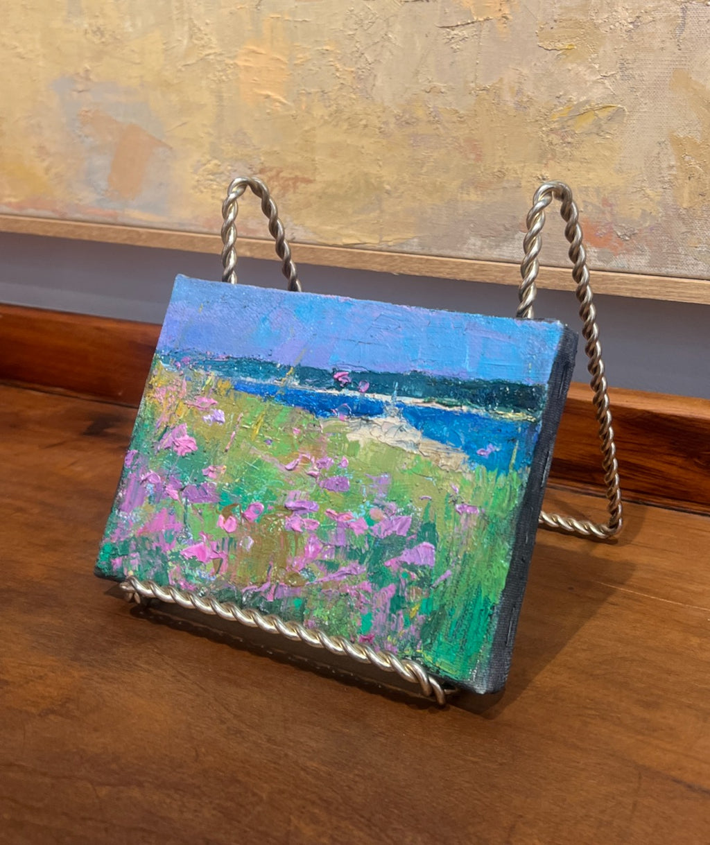 impressionist style oil painting of pink flowers in dune grass with beach and water