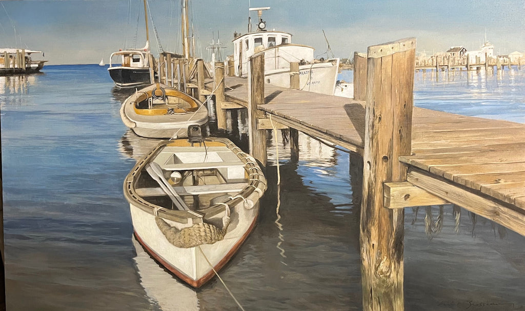 Boats tied to the dock reflect in the beautiful water beneath them