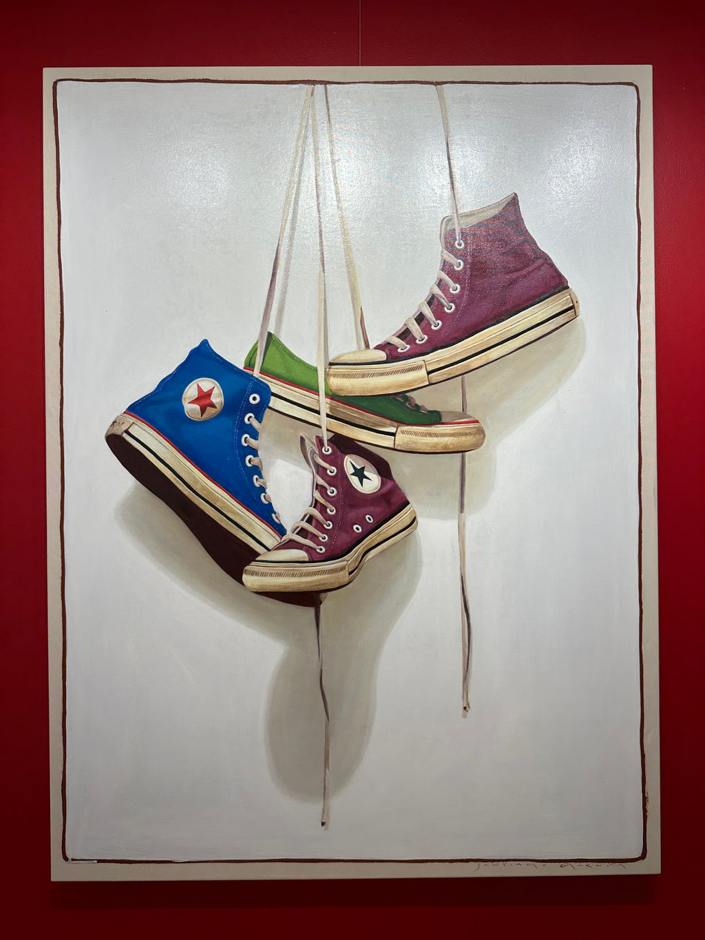 oil painting of blue, green, and deep purple converse sneakers hanging by laces