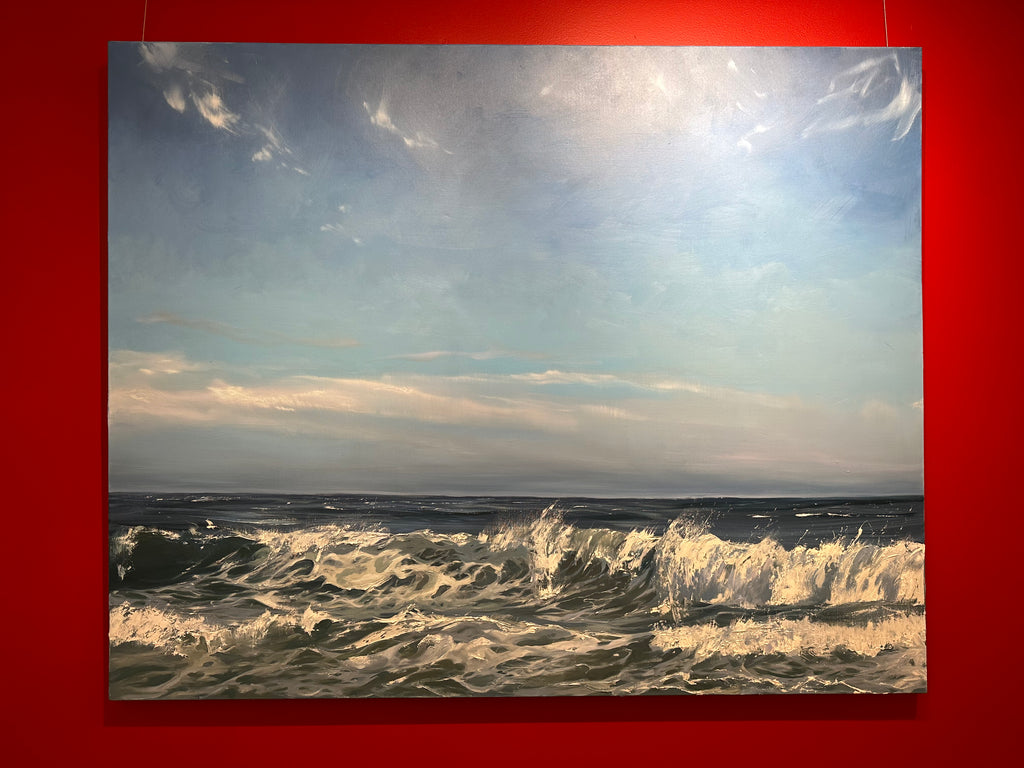 Large scale oil painting of waves in a blue ocean with light blue sky 