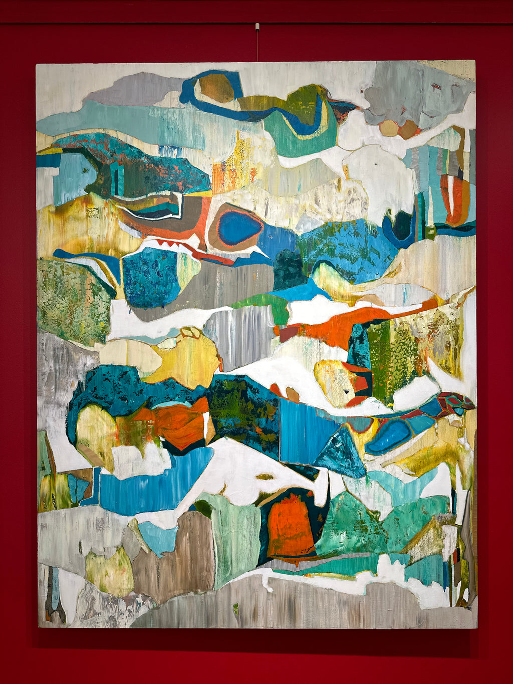 Abstract vertical oil on canvas painting with greens, blues, grey, and specks of red.