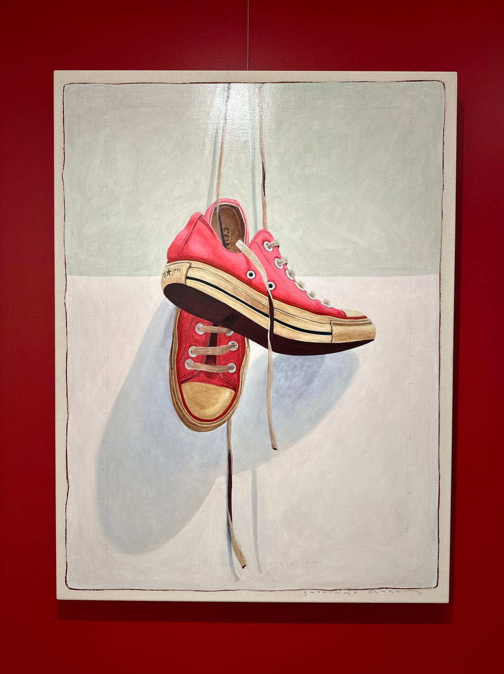 oil painting of pink low top converse sneakers hanging by laces