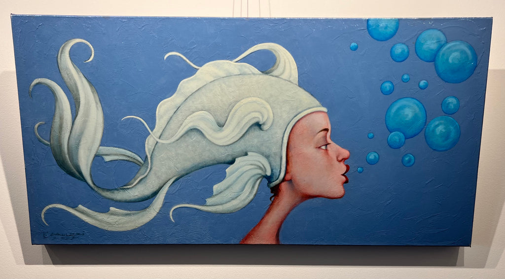 portrait painting of a woman in a fish cap, red lips, and rosy skin blowing blue bubbles on blue background