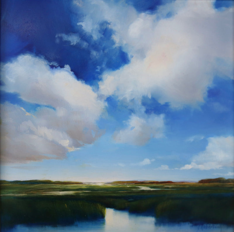 Deep blue sky resting over a ponded marsh