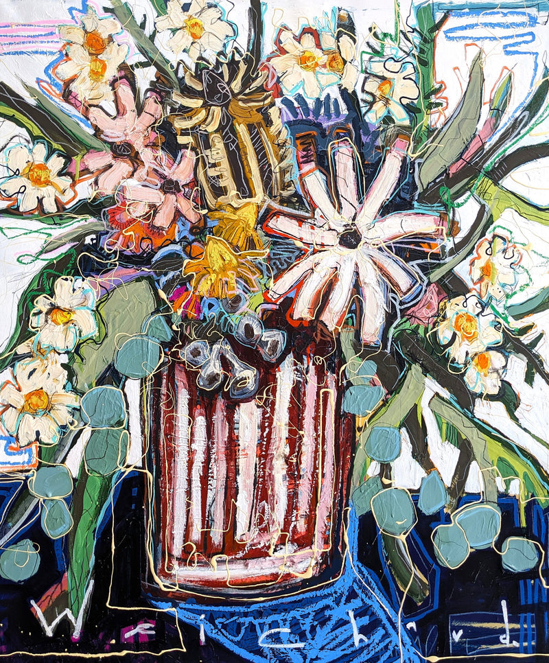 Flowers stand tall in a vase surrounded by hues of blue