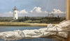 Oil painting of a folded sail with beach and Edgartown Lighthouse behind