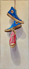 oil painting of dark blue, light blue, and pink high top converse sneakers hanging by laces on off white canvas