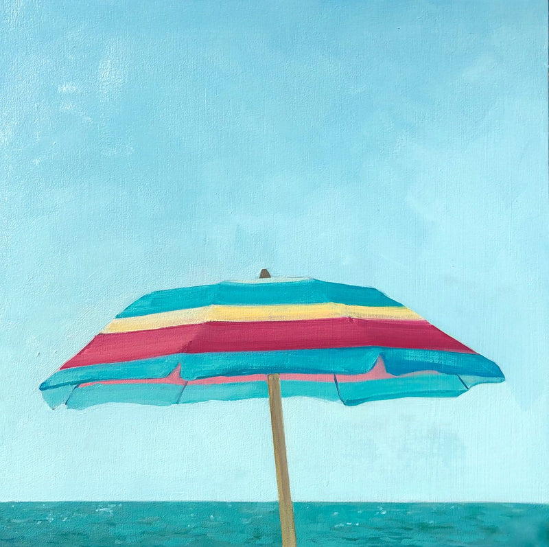 small scale oil painting of pink, yellow and turquoise beach umbrella with blue sky and ocean behind 