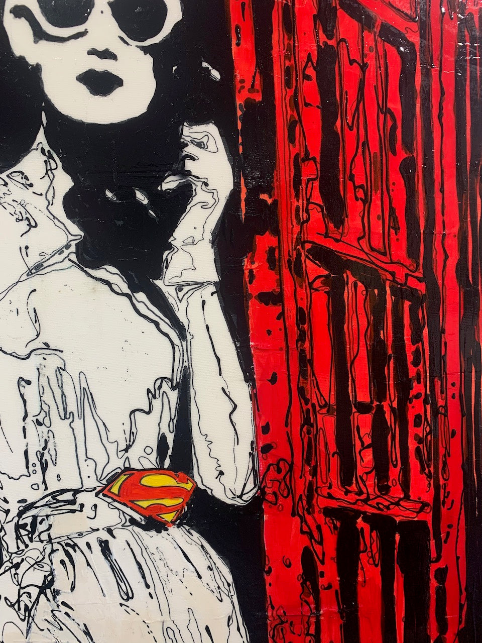 Mixed media painting by Holly Manneck of a woman poses in a red telephone box wearing sunglasses and a Superman belt buckle while holding the phone as a person with a Superman briefcase walks out of view