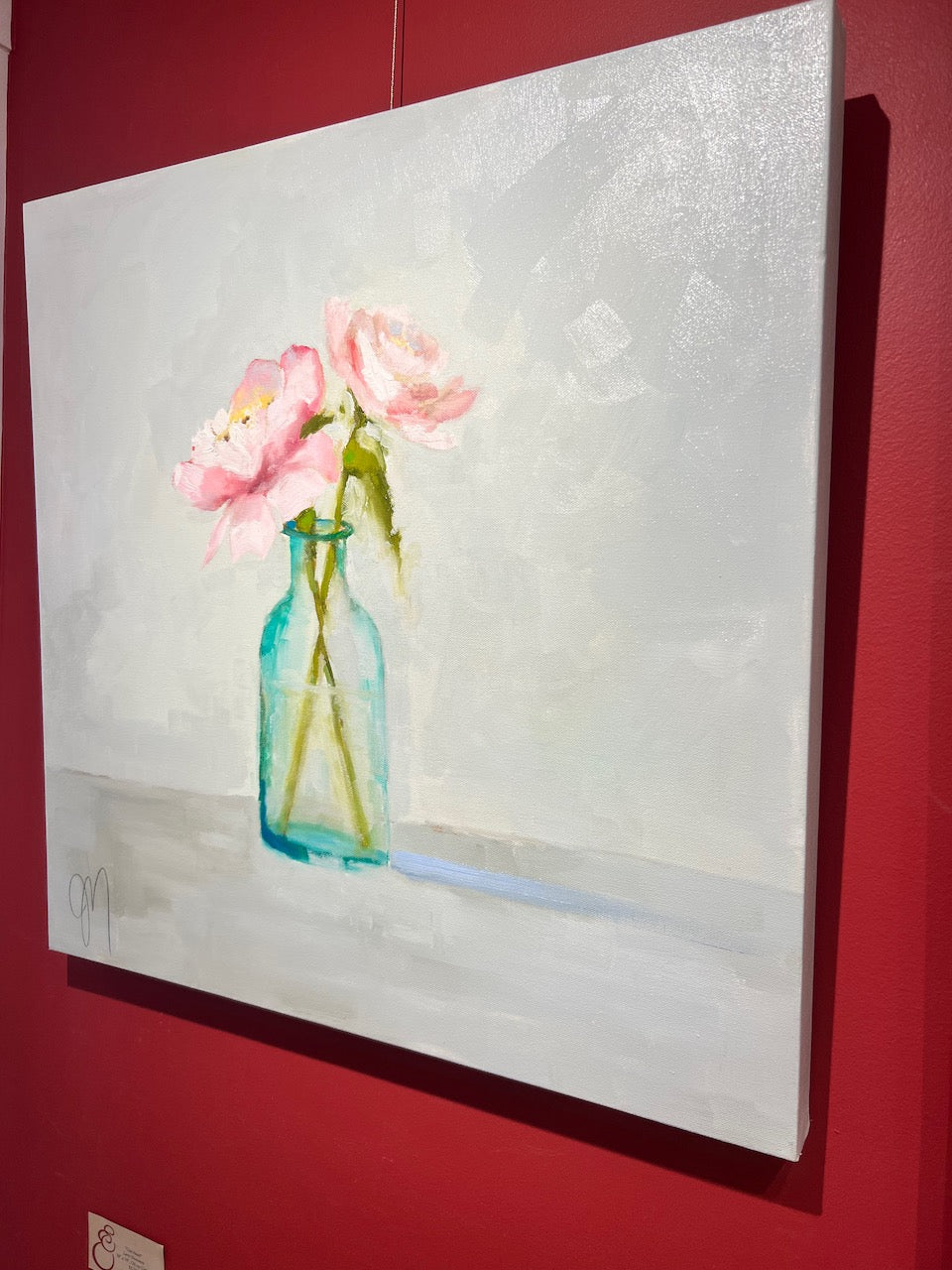 impressionist style still life oil painting or two pink flowers in a clear blue vase