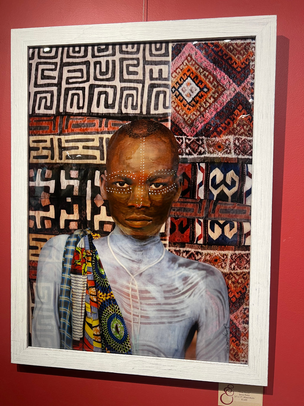 Mixed media painting of an African man with white tribal paint and a white shirt on African patterned background