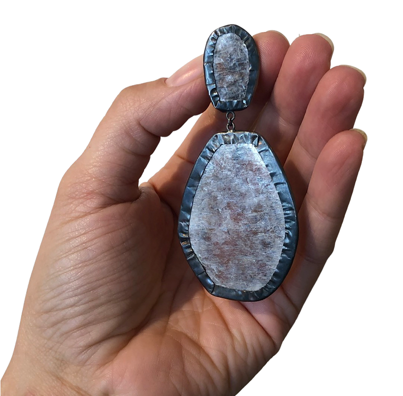 Oxidized silver wraps lavender mica in this light and bold statement clip on earring. 3 & 1/4" long x 1 & 1/2" wide”.