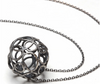 Oxidized sterling silver soldered circles make ball. 1" in diameter suspended on 18" cable chain with handmade clasp.