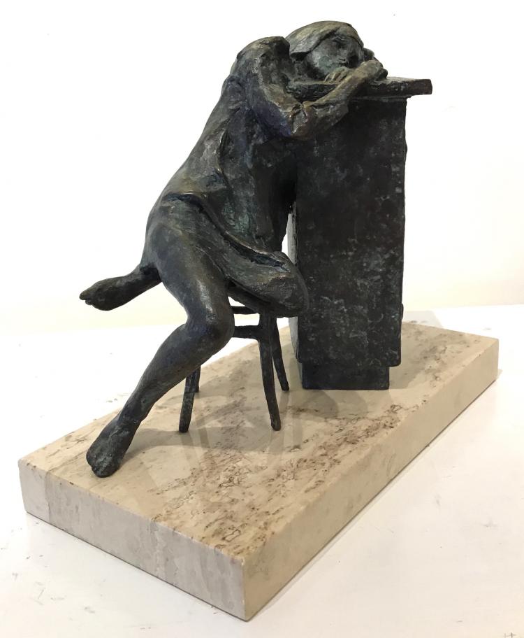Figure bronze sculpture of a girl sitting in a chair resting her arms and head on a desk