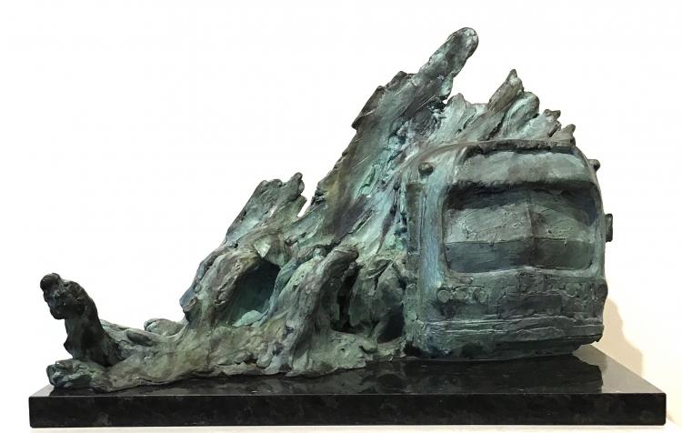 Abstract bronze sculpture by Stanley Bleifeld with people entering and exiting bus under snow bank.