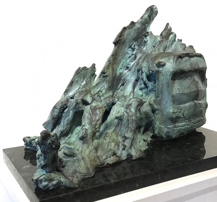 Abstract bronze sculpture by Stanley Bleifeld with people entering and exiting bus under snow bank.