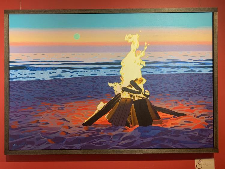 Oil painting by Rob Brooks of a bonfire on the beach emitting a warm glow on the sand around it with the ocean front and a pastel sunset with the moon in the sky behind it.