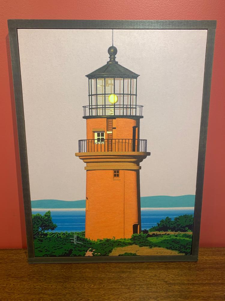 Oil painting by Rob Brooks of an orange lighthouse on a grassy beach. The green hills behind it are separated by a body of water and beach front.