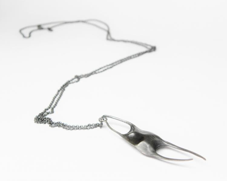 Sterling silver skate egg cast necklace